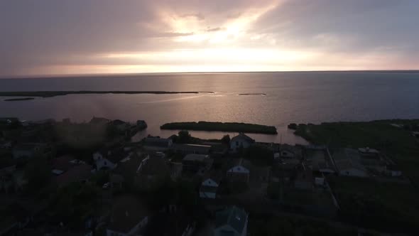 Drone View of Sunset in the Clouds Over the Seaside Village on the Belosaraiskaya Spit