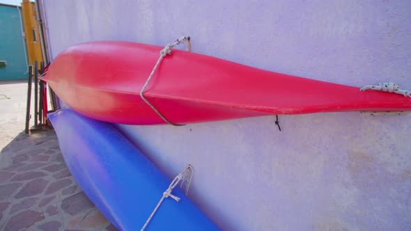 Canoe Boats Attached Tightly to Wall of House in Burano alt