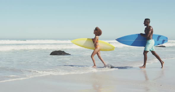 African American couple ready to go surf alt