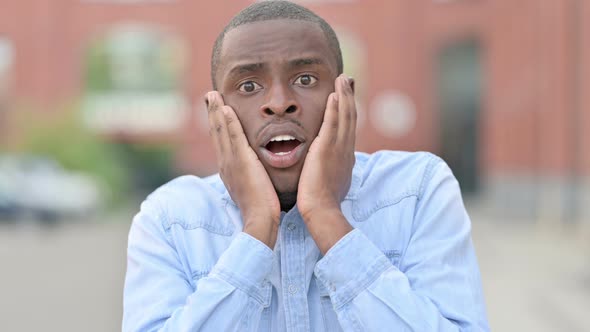 Outdoor Portrait of Young African Man Reacting To Loss, Failure  alt