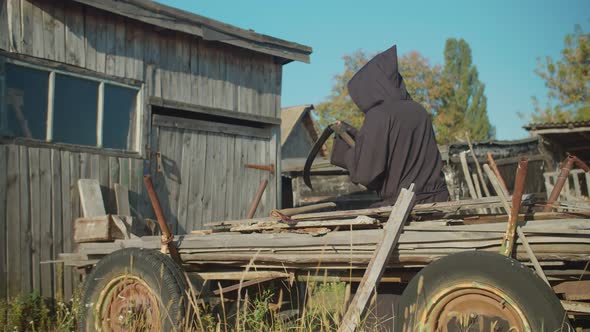 Rear View of Grim Reaper Sharpening Scythe Outdoor alt