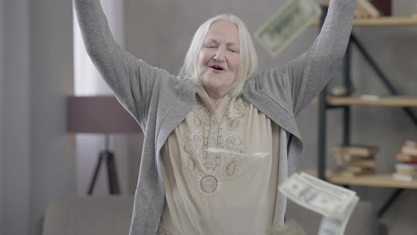 Cheerful Rich Old Caucasian Woman Throwing Money Falling in Slow Motion alt