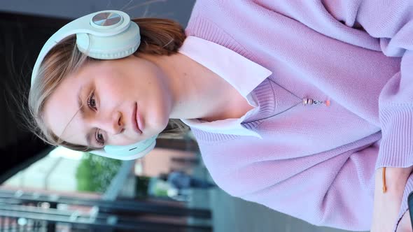 Melancholic Lady Student in Earphones Listens to Music alt