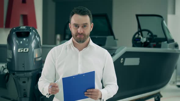 Dealer of Sailboats Is Signing Documents in the Showroom alt