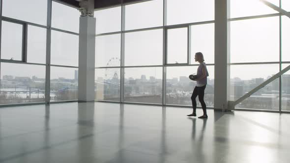 Young Woman Alone In Gym Hall alt
