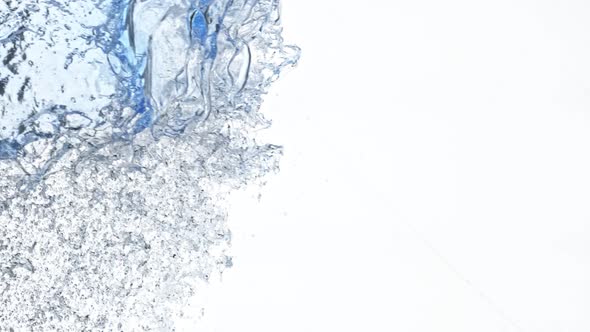 Super Slow Motion Shot of Side Water Splash Isolated on White Background at 1000Fps alt