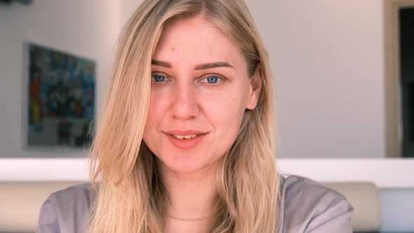 Confident Young Beautiful Blueeyed Blonde Woman Without Makeup Looks Into the Camera