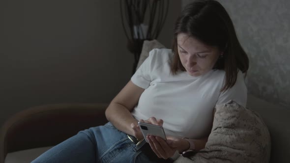 Brunette Woman Uses Phone