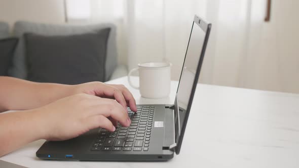 Workaholic doing activities at home and drinking coffee. alt