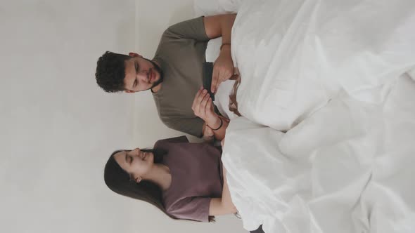Young Latino Couple Looking At Pregnancy Test alt