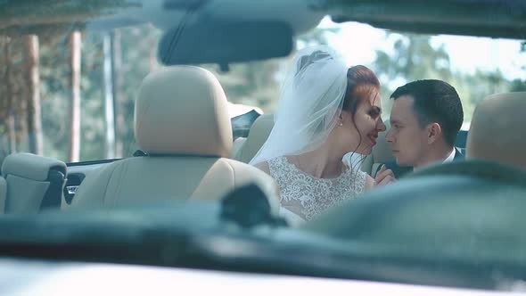 Newlyweds Sitting Car Convertible Look at Each Other Experience Feelings of Tenderness alt