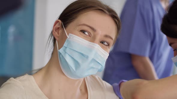 Tracking video of happy woman taking selfie during vaccination. Shot with RED helium camera in 8K. alt
