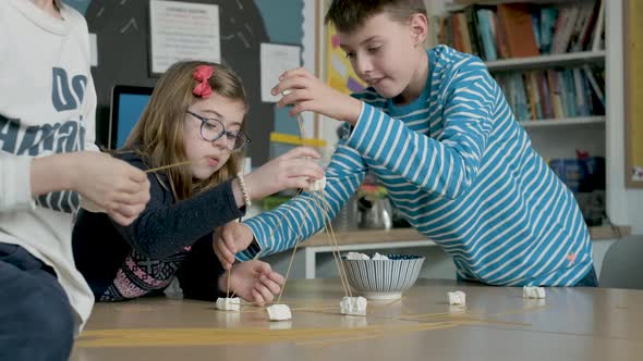 Children setting up construction during a science lesson alt