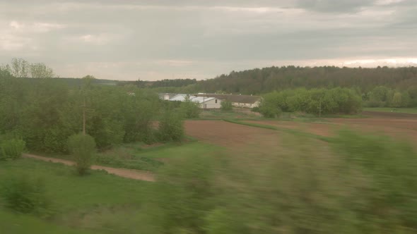 View From Window of Highspeed Train on Landscape of Beautiful Nature Wild Field and Forest on alt