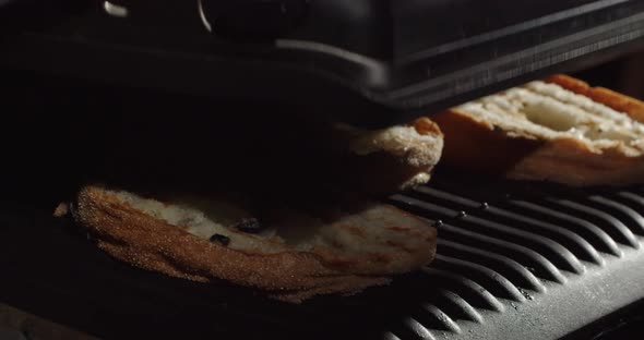 Open The Grill Lid And Remove The Hot Toasted Piece Of Bread
