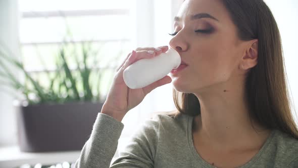 Healthy Drink. Beautiful Woman Drinking Natural Yogurt alt