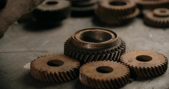 Technician is Trying on the Gears to Make Mechanism at Workshop Tech Stuff at the Repair Garage alt
