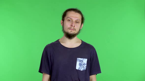 Portrait of a Young Man Looking at the Camera Tired and Sighing alt