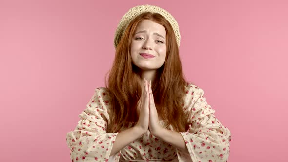 Cute Young Girl in Dress Praying Over Pink Background. Woman Begging Someone Satisfy Her Desires alt