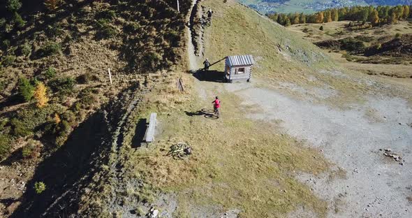 Aerial drone view of a group of mountain bikers on a singletrack trail. alt