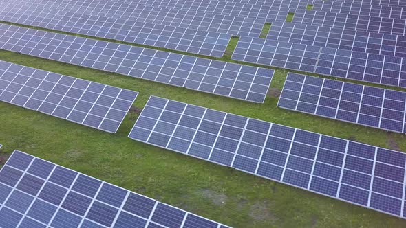 Aerial View of Big Sustainable Electric Power Plant with Many Rows of Solar Photovoltaic Panels for alt