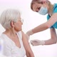 An Elderly Worried Woman Getting Vaccinated for Virus Protection By a Professional Nurse at the - VideoHive Item for Sale