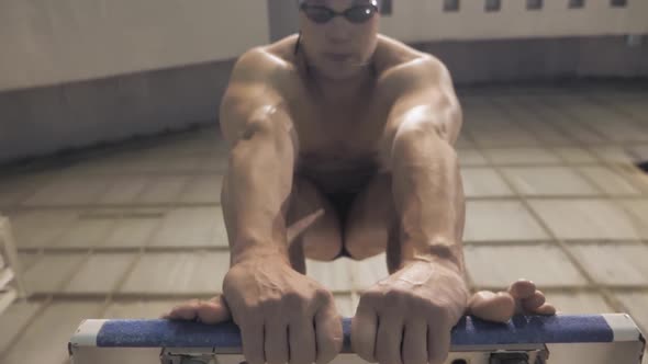 Man Swimmer at Start Place,Close Up of Swimmer's Legs and Hands Before Start Off alt