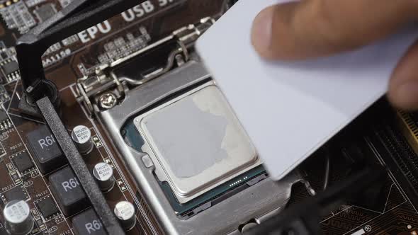Close Up Shot of Applying Thermal Paste on CPU alt