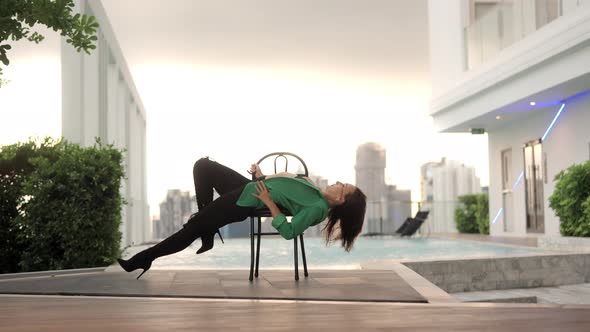 Dancer In Green And High Heels Bending Over Backwards alt