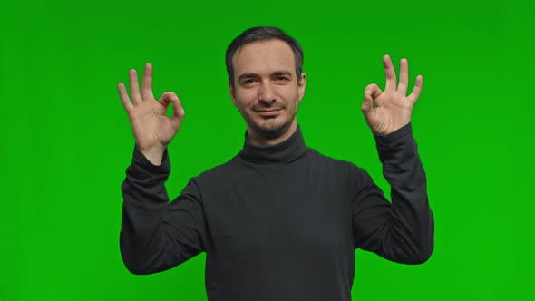 Positive Young Man Smiles to Camera alt