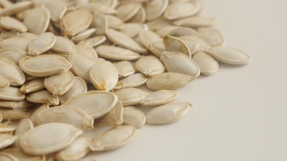 Close-up of edible pepita  slow tilt 4K 2160p 30fps UltraHD footage - Pumpkin seed on pile 3840X2160 alt