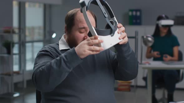 Portrait of Overweight Employee Remove Vr Headset and Massage Tired Eyes alt
