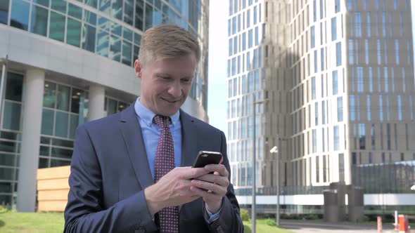 Businessman Using Smartphone alt