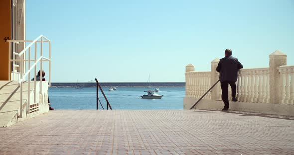 Unrecognizable Elderly Man Watching the Sea and Getting Fresh Air By the Seaside alt
