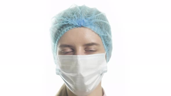 Portrait of a Female Doctor in Medical Uniform is Looking at Camera at Hospital Close Up alt