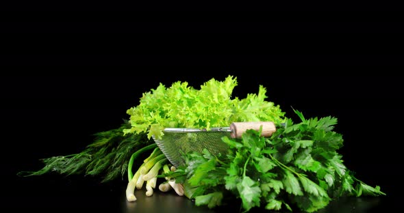 Fresh Healthy Greens in a Colander Rotates Slowly.  alt