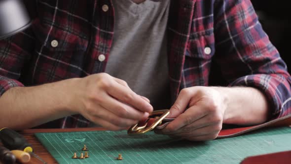 Man Tailor Cutting Artificial Leather with Ruler Closeup alt