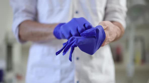 Closeup Unrecognizable Doctor Ripping Medical Gloves Indoors alt