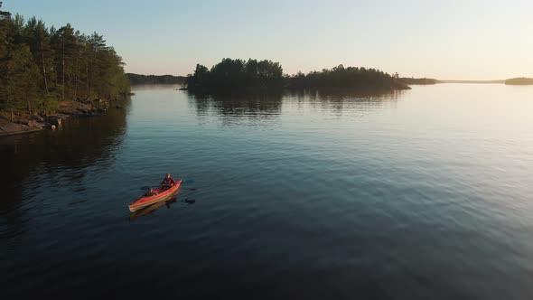 Stunning Landscape of the Lake at Sunset, a Young Mother and a Child Float on a Red Kayak, Active alt