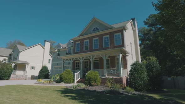 Footage of a beautiful house in the suburbs on a clear sunny day alt