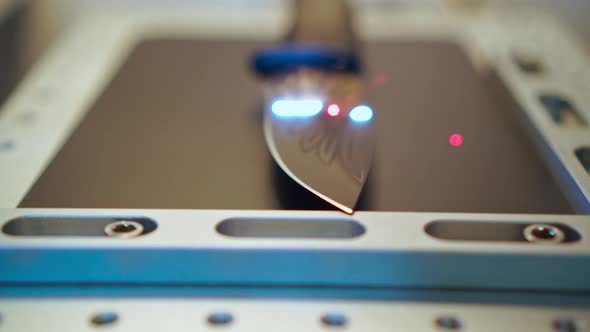 Hunting Black Knife on Laser Machine Work Platform in Engraving Processlaser Beam Moving Camera