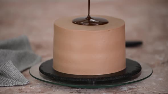 Pouring Chocolate Sauce Onto Delicious Cake Closeup