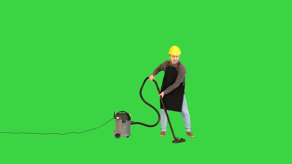 Worker Cleaning Floor with Vacuum Cleaner Dancing and Singing on a Green Screen Chroma Key