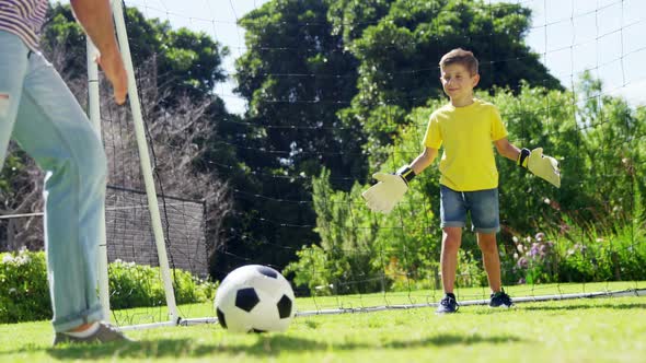 Father and son playing football alt