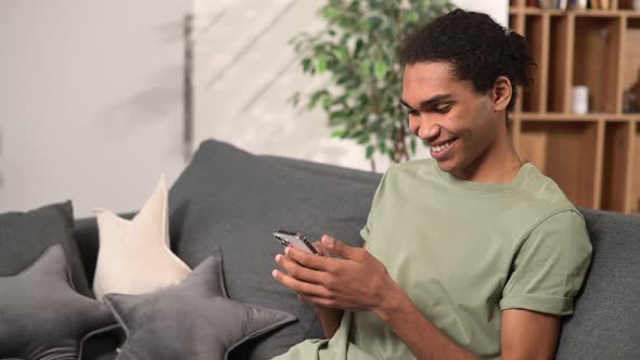 Young Handsome Indian Freelancer Man Using Smartphone for Online Chatting in Social Media alt