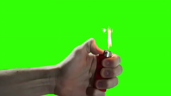 Hand holding a Lighter on Green Chroma Key Screen. 4K Version. 