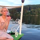 A Girl in a Sundress Sits on the Dock and Drinks Red Wine From a Glass - VideoHive Item for Sale