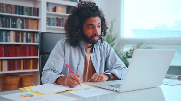Young African American Male Student with Headset in an Online Lesson in College alt