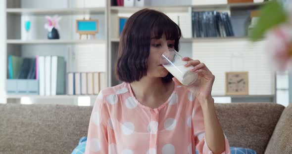 Asian young woman thump up for good taste of milk alt