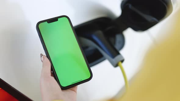 Green Screen Mock Up Chroma Key on Mobile Phone EV Charging Station for Electric Car with Mobile App